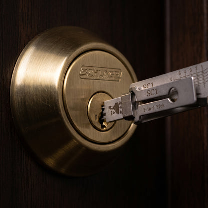 Pick and decoder tool inserted into a brass pin tumbler cylinder
